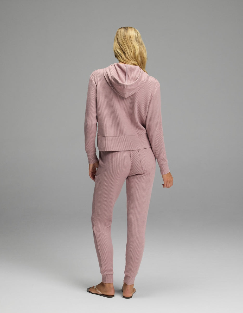 Back view of a person wearing a mauve-colored Women’s Blake Waffle Hoodie & Jogger Set in a textured waffle-knit fabric.