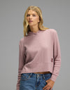 A woman wears a mauve, long-sleeved Cozy Earth Women’s Blake Waffle Hoodie.|Color:Viola