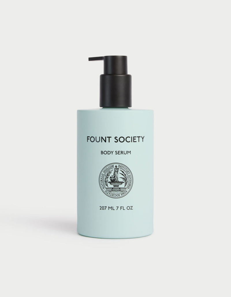 A light blue bottle with a black pump, labeled "Cozy Earth Wrap & Renew Bundle," features a circular emblem in the center.