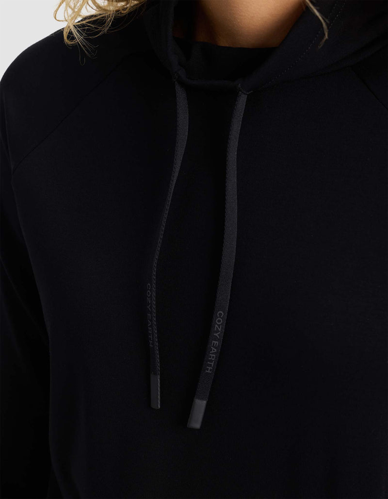 Close-up of a person wearing the Cozy Earth Women's Brushed Bamboo Mock Neck with black drawstrings featuring "COZY EARTH" text. Only part of the person's face, neck, and hair are visible.