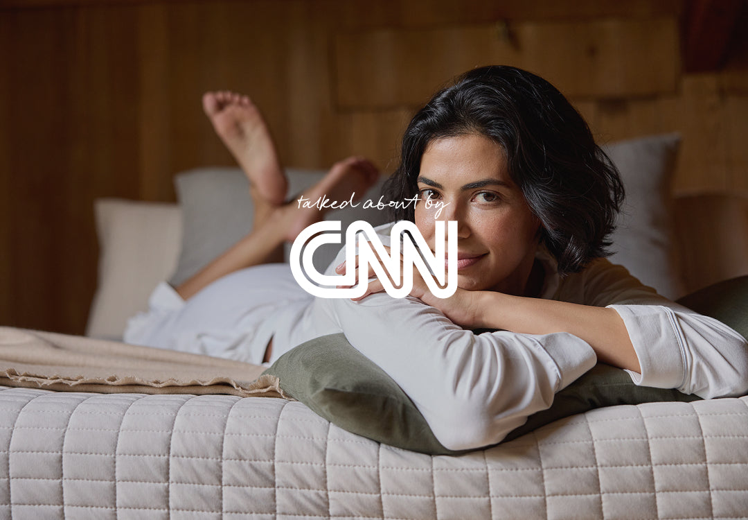 Woman lying on a bed with CNN logo overlay