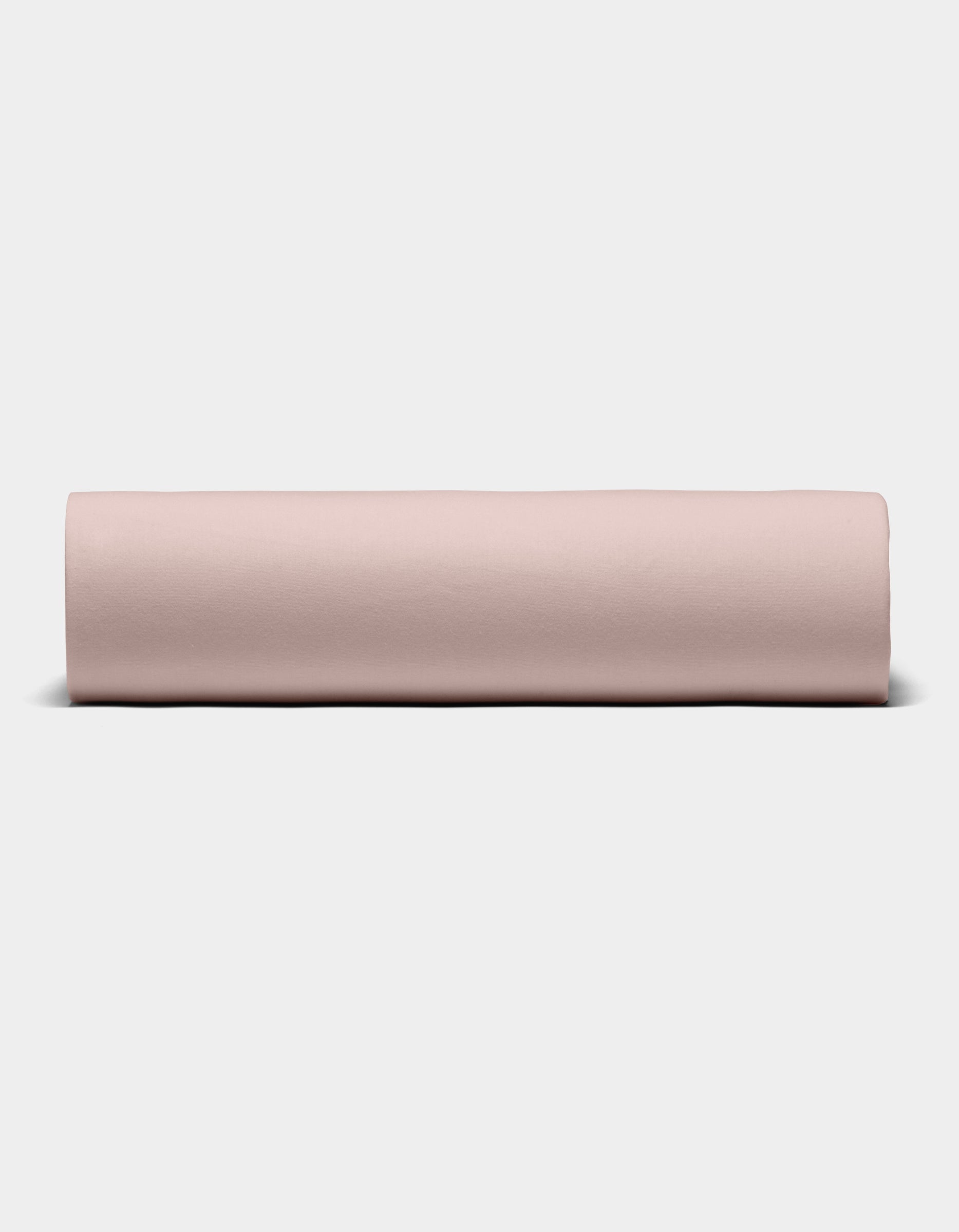 The Cozy Earth Bamboo Jersey Sheet Set is shown rolled into a neat cylinder, displayed from the front against a plain white background.|Color:Petal