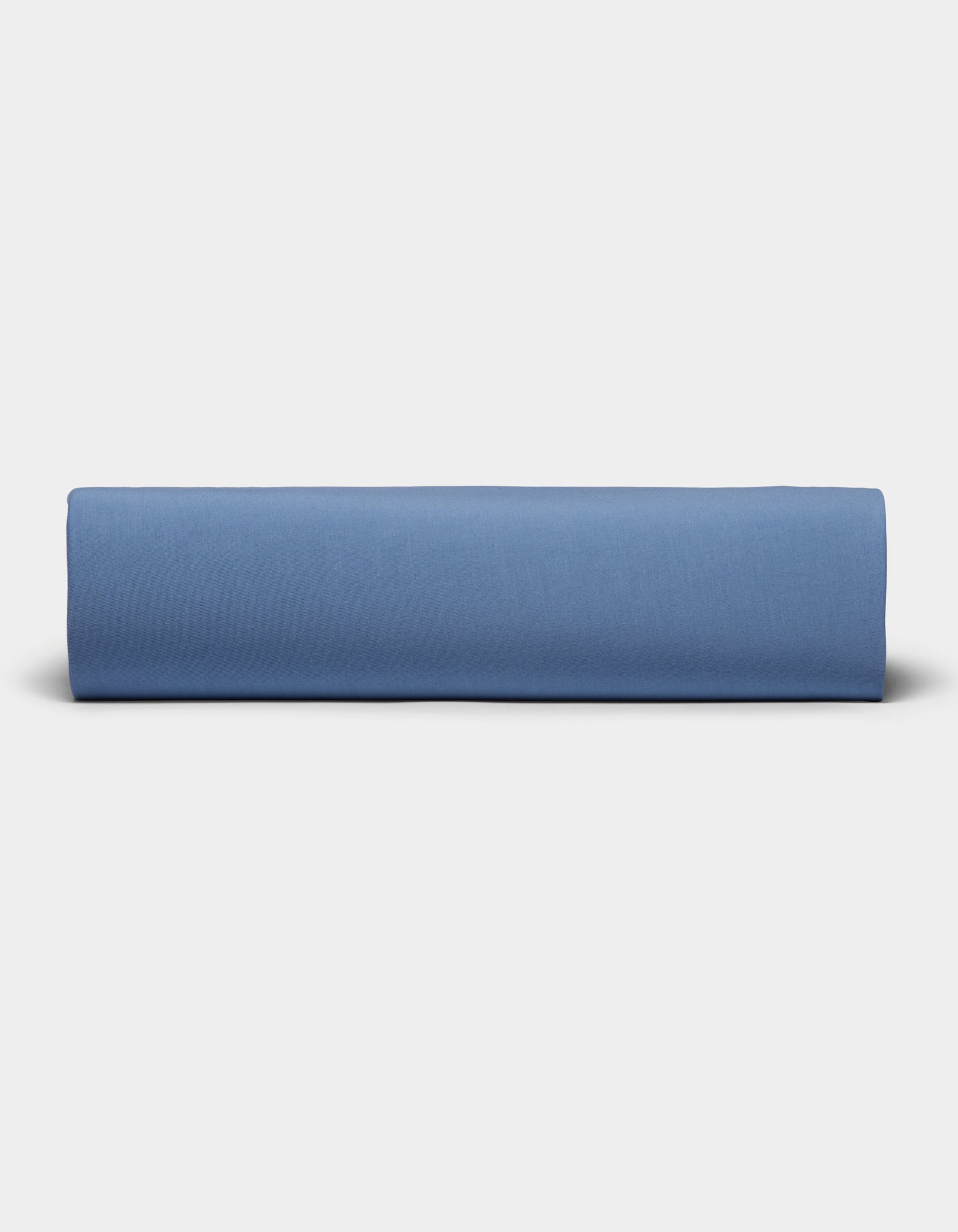 A neatly folded Bamboo Jersey Sheet Set by Cozy Earth is displayed against a plain, light gray background.