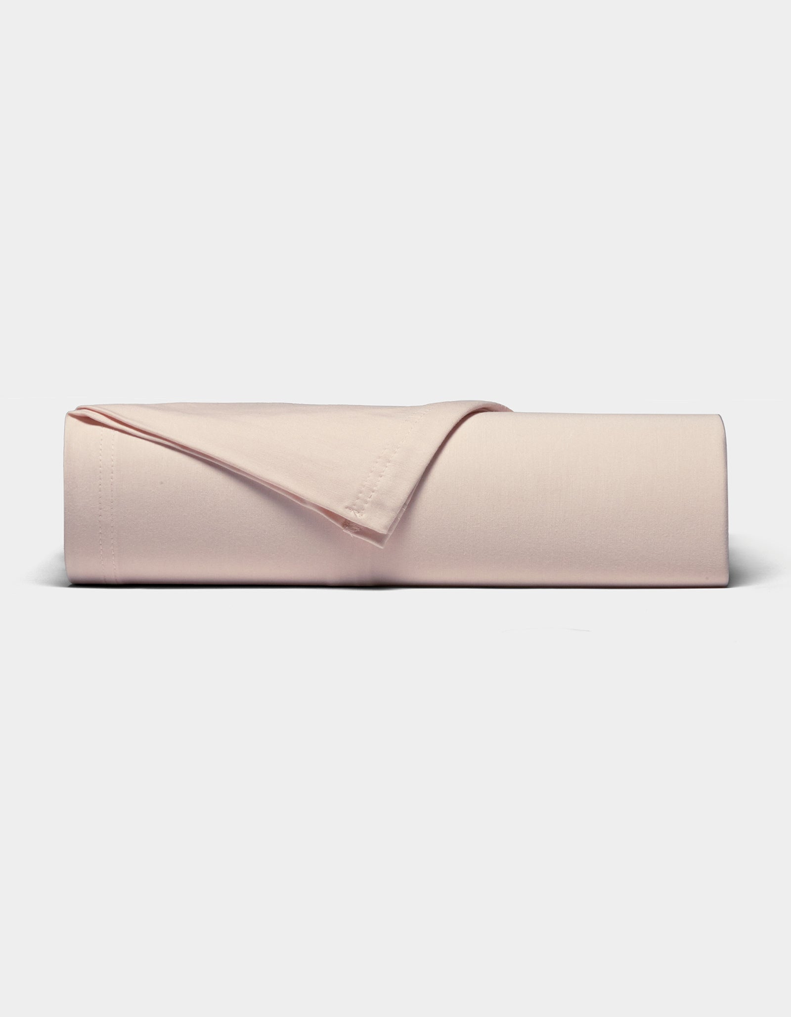 The Cozy Earth Bamboo Jersey Sheet Set, in light pink, is neatly folded and displayed on a plain white background.