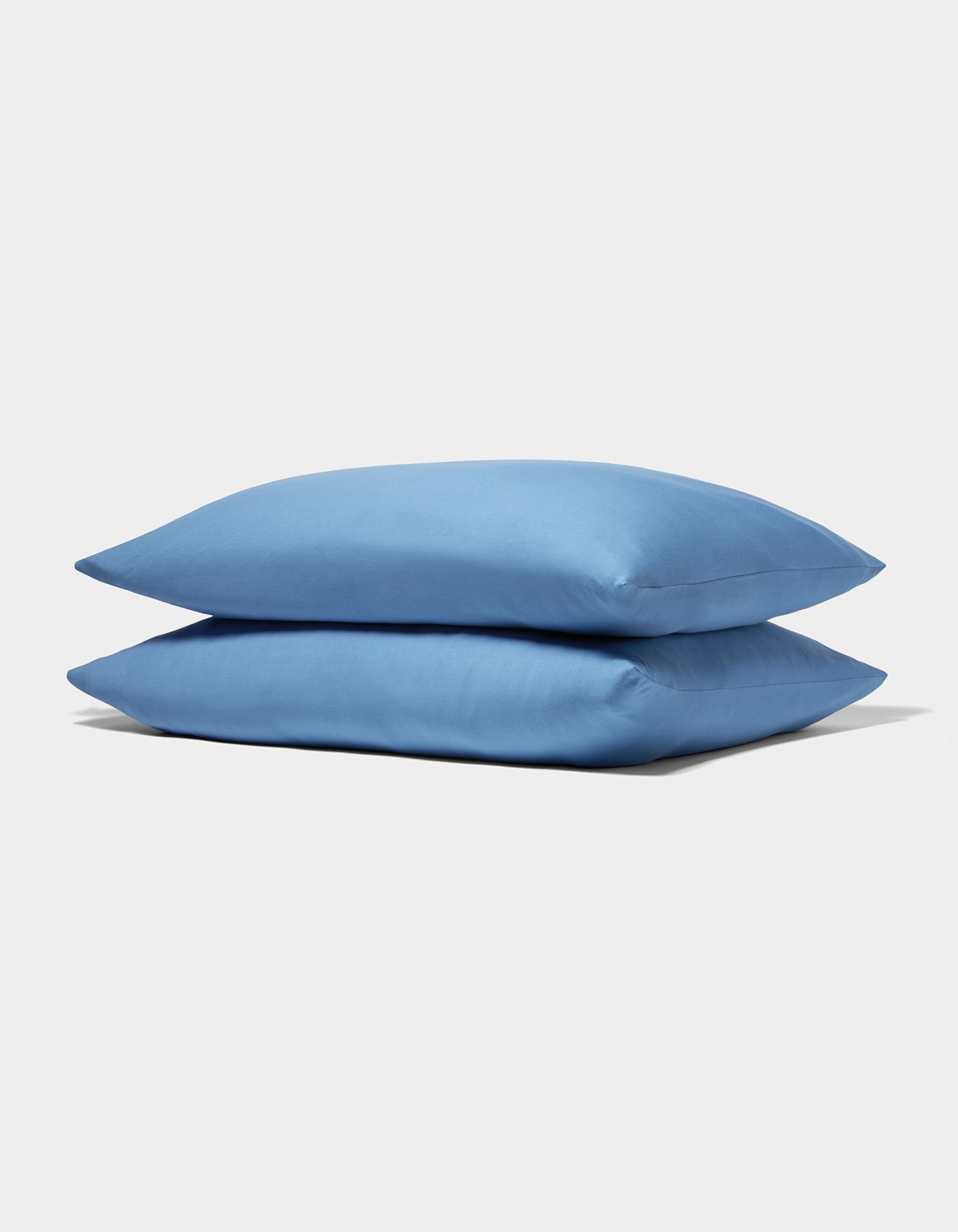 Two neatly stacked Cozy Earth Bamboo Jersey Pillowcases in light blue are displayed on a plain white background.|Color:Sailor