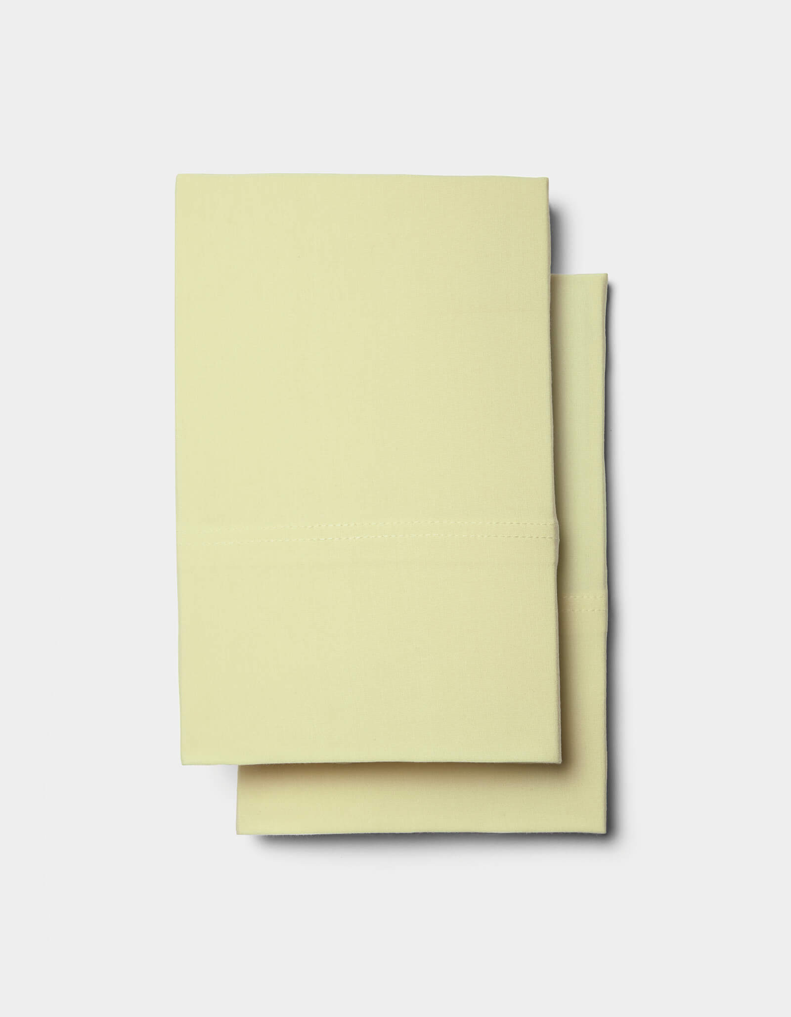Two neatly folded Cozy Earth Bamboo Jersey Pillowcases are stacked on a plain white background.