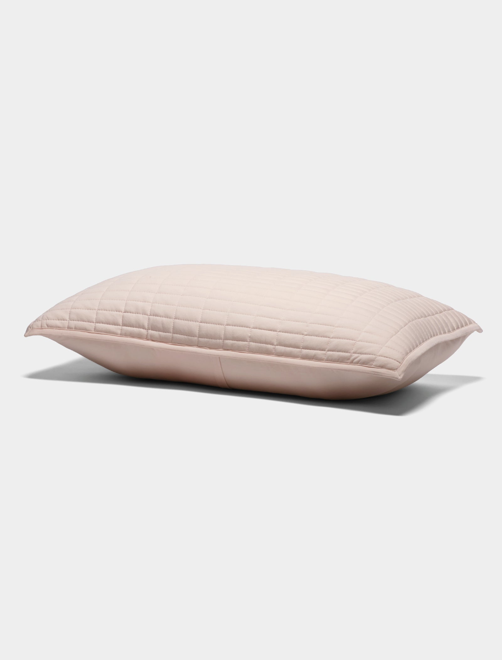 The Cozy Earth Bamboo Jersey Quilted Shams features a light pink rectangular design with a quilted pattern, displayed on a plain white background.