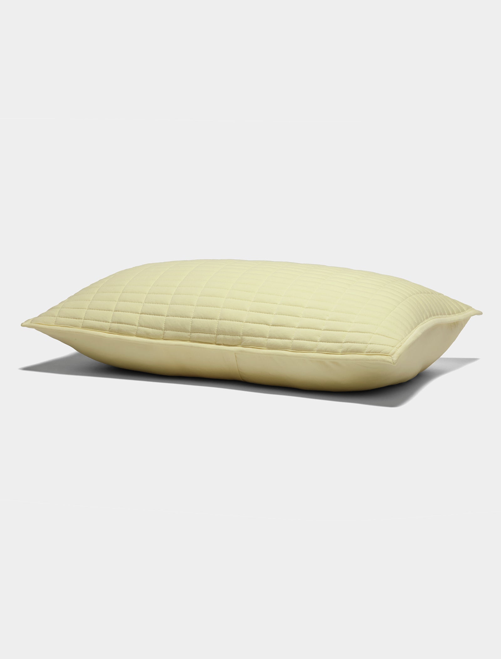 The Cozy Earth Bamboo Jersey Quilted Shams in light yellow, featuring a smooth quilted texture, are displayed against a plain white background.