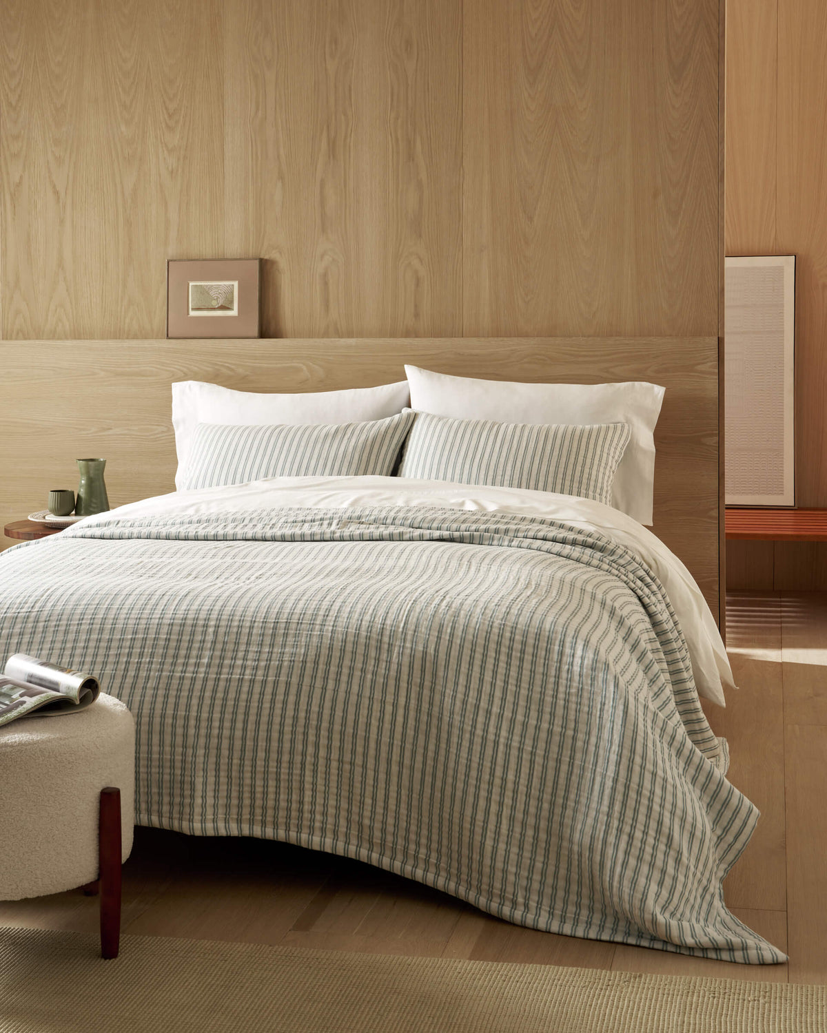 Someone wears Cozy Earth's Ribbed Terry Bath Wrap in beige, featuring ribbed fabric and large front pockets—one hand rests inside a pocket with the Cozy Earth label showing.|Color:Petal