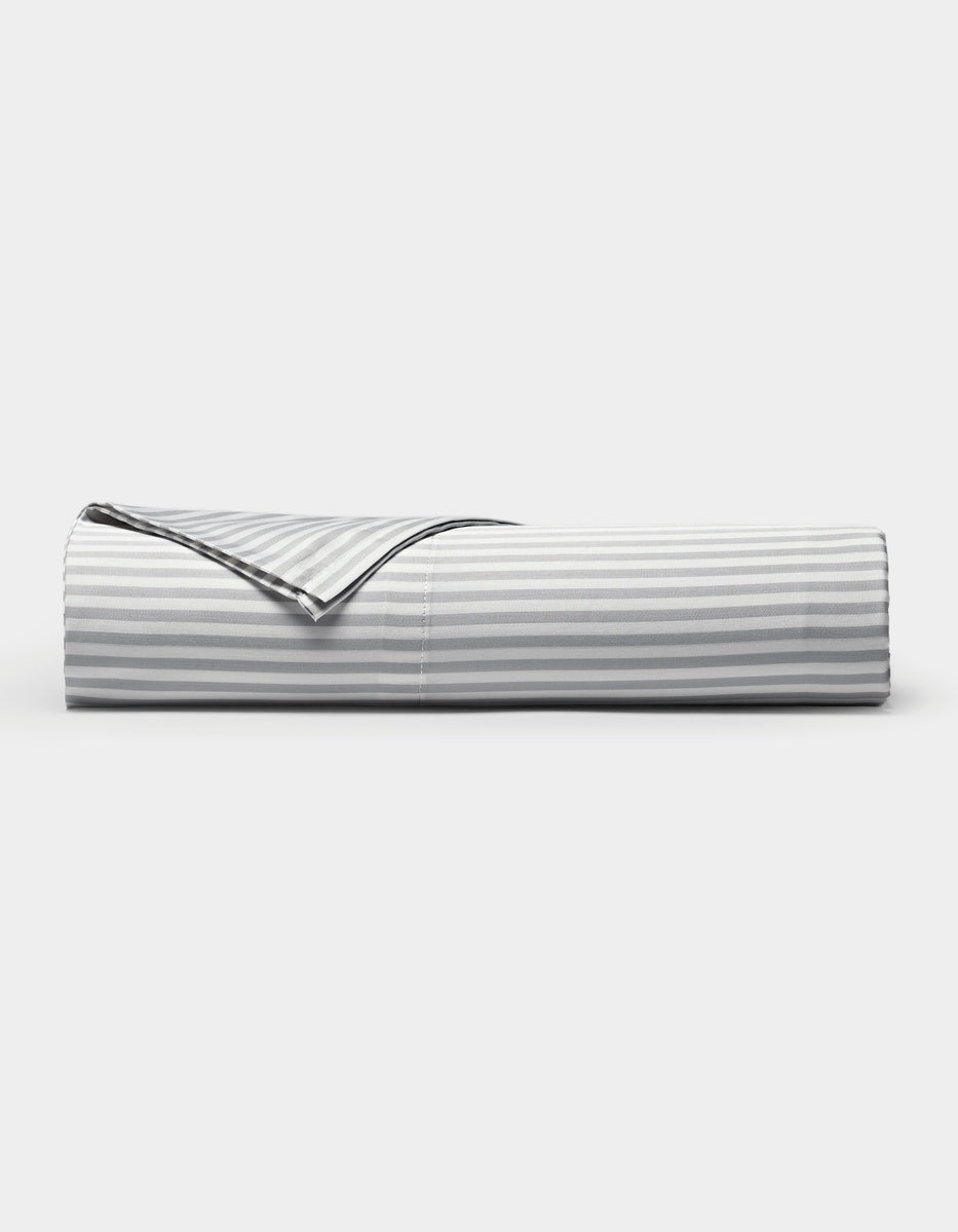 A neatly folded Cozy Earth Bamboo Flat Sheet in a gray and white striped pattern is displayed against a plain white background.