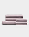 A neatly folded set of Cozy Earth Bamboo Bedding Core Bundle sheets and pillowcases, including both flat and fitted sheets, arranged against a plain white background.|Color:Lavender