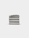 A neatly stacked pile of five folded light gray Ribbed Terry Washcloths by Cozy Earth is centered on a plain white background.|Color:Dew Stripe