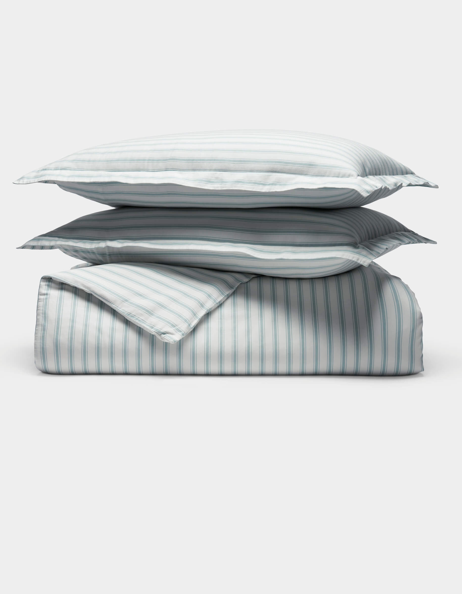 The Cozy Earth Soft-Wash Cotton Duvet Set is displayed neatly folded with two stacked pillows and a comforter, all in a light blue and white vertical striped pattern, set against a plain white background.