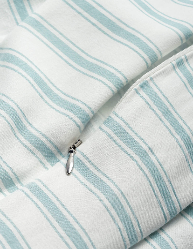 Close-up of the Cozy Earth Soft-Wash Cotton Duvet Cover in white with light blue stripes, highlighting a partially unzipped silver zipper.