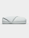 The Cozy Earth Soft-Wash Cotton Duvet Cover features neat light blue and white vertical stripes, displayed folded on a plain white background with one corner turned to show the underside pattern.|Color:River and Sea Salt Stripe