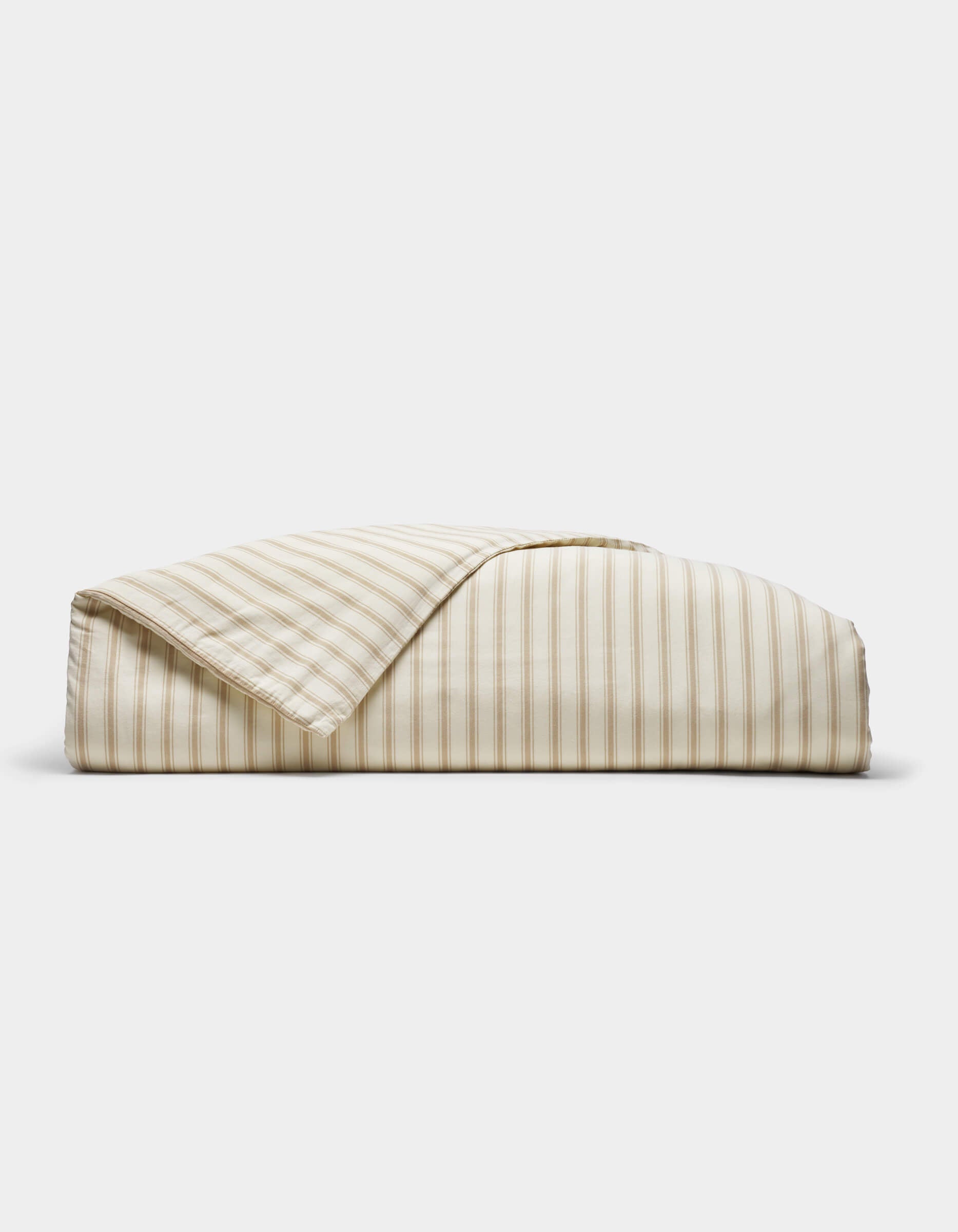 The Cozy Earth Soft-Wash Cotton Duvet Cover, featuring beige and white vertical stripes, is neatly folded and displayed against a plain white background.