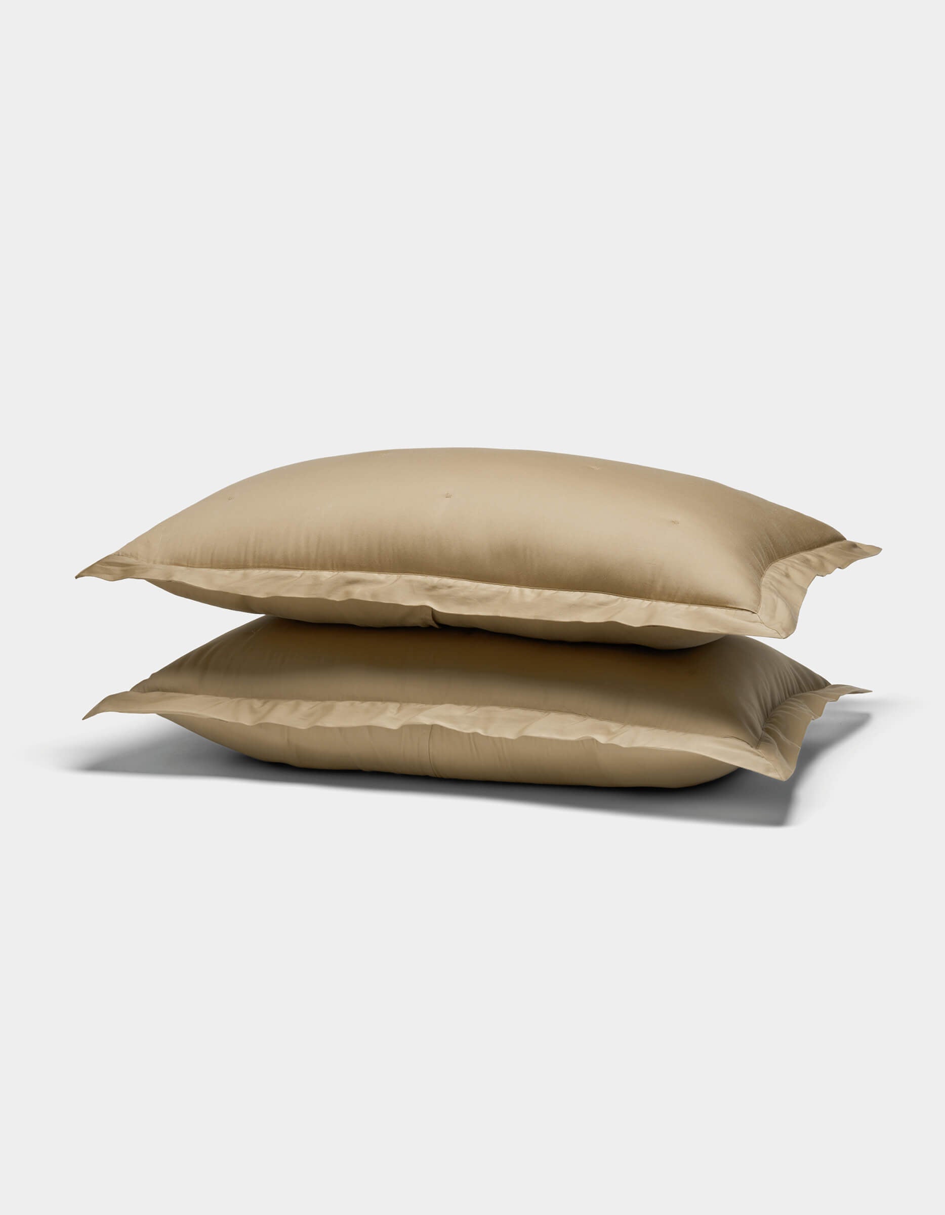 Two Cozy Earth Soft-Wash Cotton Quilted Shams, in beige, are stacked on top of each other against a plain white background.