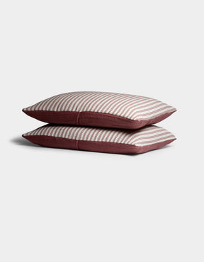 Two Waterfront Shams by Cozy Earth are stacked, showing a white top with thin horizontal red stripes and solid red sides, set against a plain light background.|Color:Currant Stripe