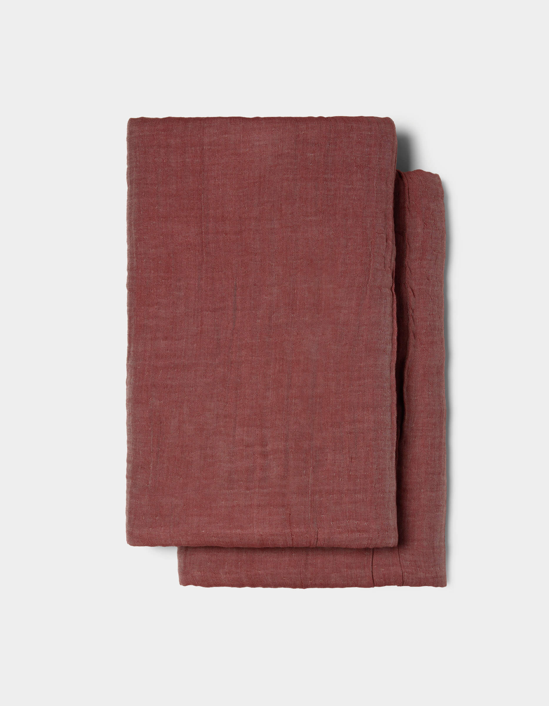 The Cozy Earth Waterfront Shams, featuring a folded, textured reddish-brown fabric, are displayed on a plain light gray background.