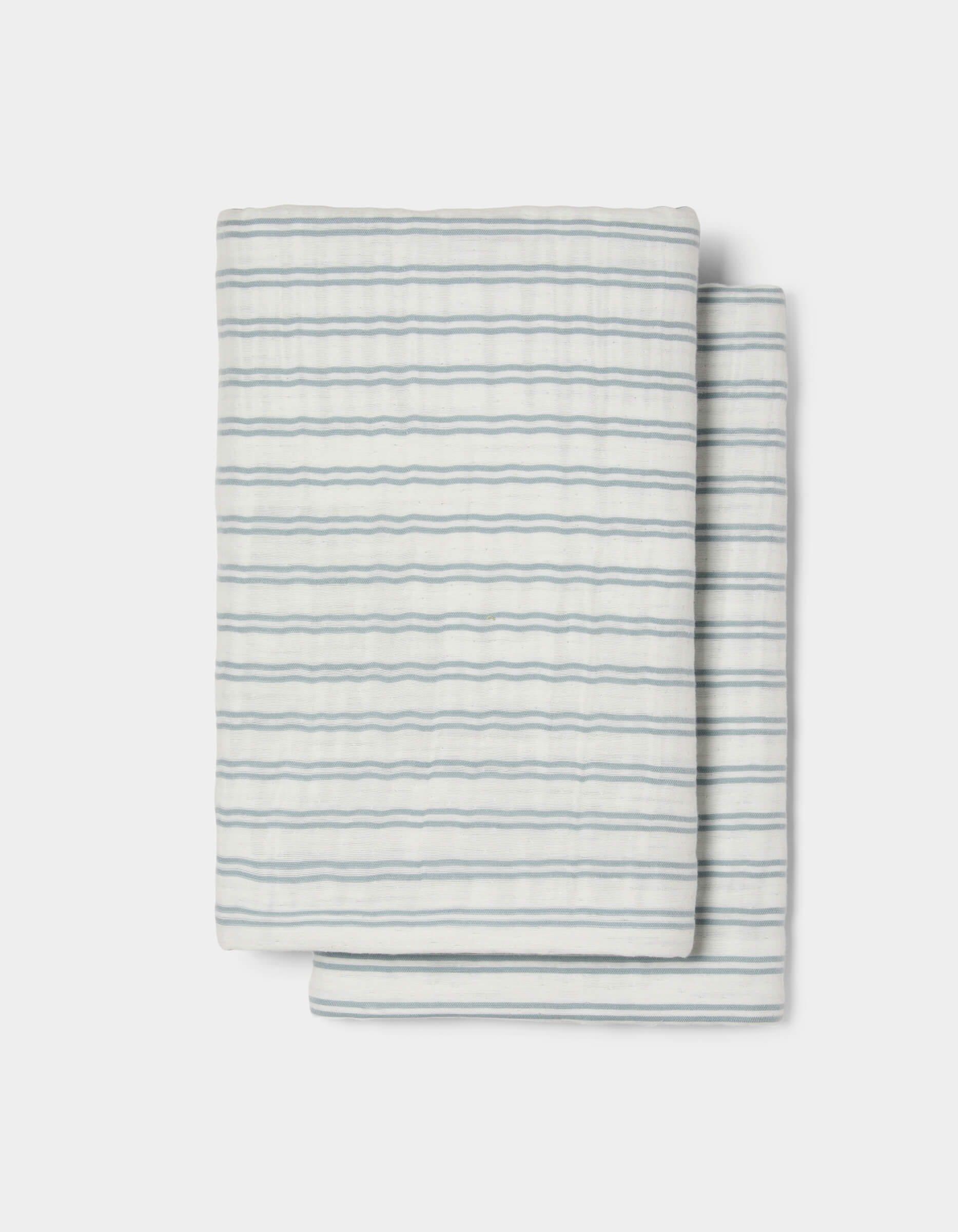The Cozy Earth Waterfront Shams feature a neatly folded white design with thin, evenly spaced horizontal blue stripes, set against a plain white background.