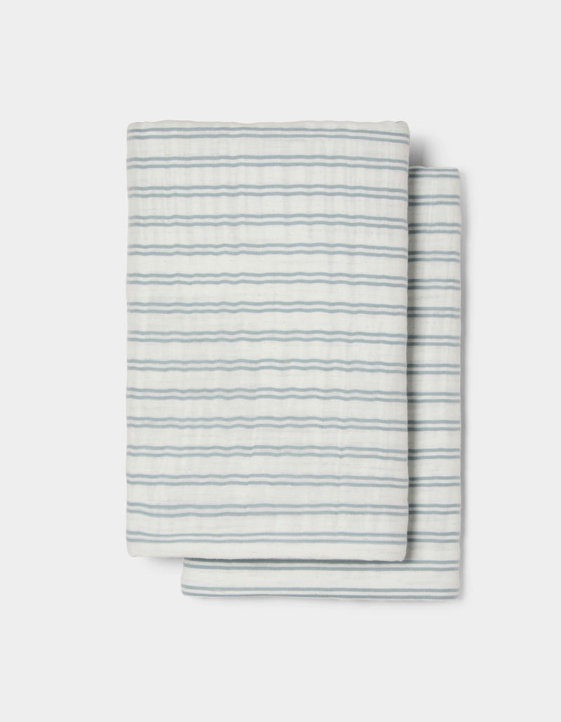 The Cozy Earth Waterfront Shams feature a neatly folded white design with thin, evenly spaced horizontal blue stripes, set against a plain white background.