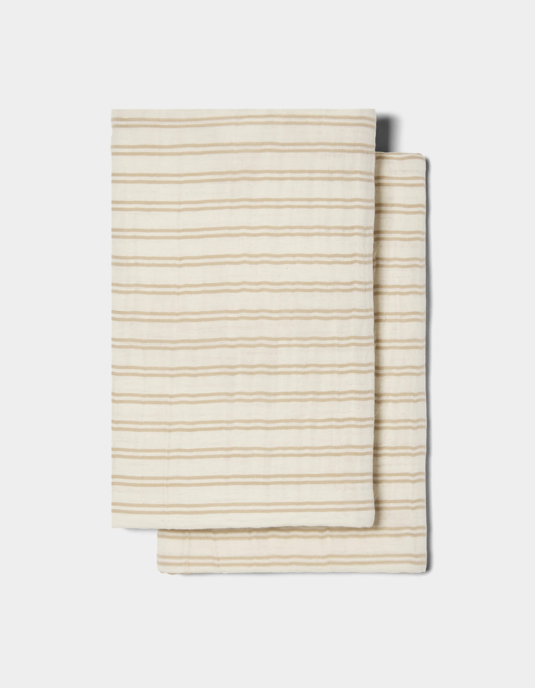 Two Waterfront Shams by Cozy Earth, cream-colored with thin horizontal beige stripes, are stacked on a white background.