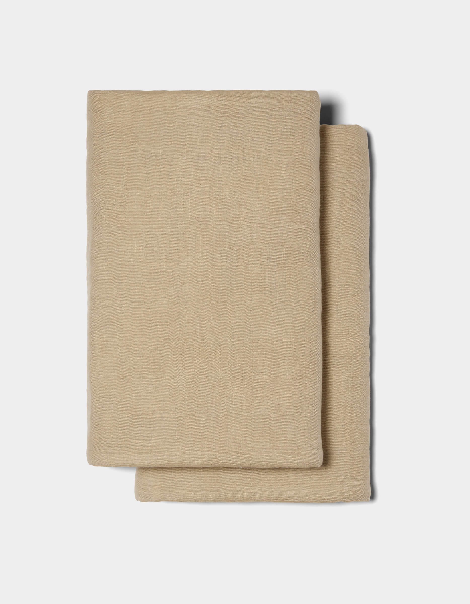 Two neatly folded Waterfront Shams by Cozy Earth in beige are stacked together against a plain white background.