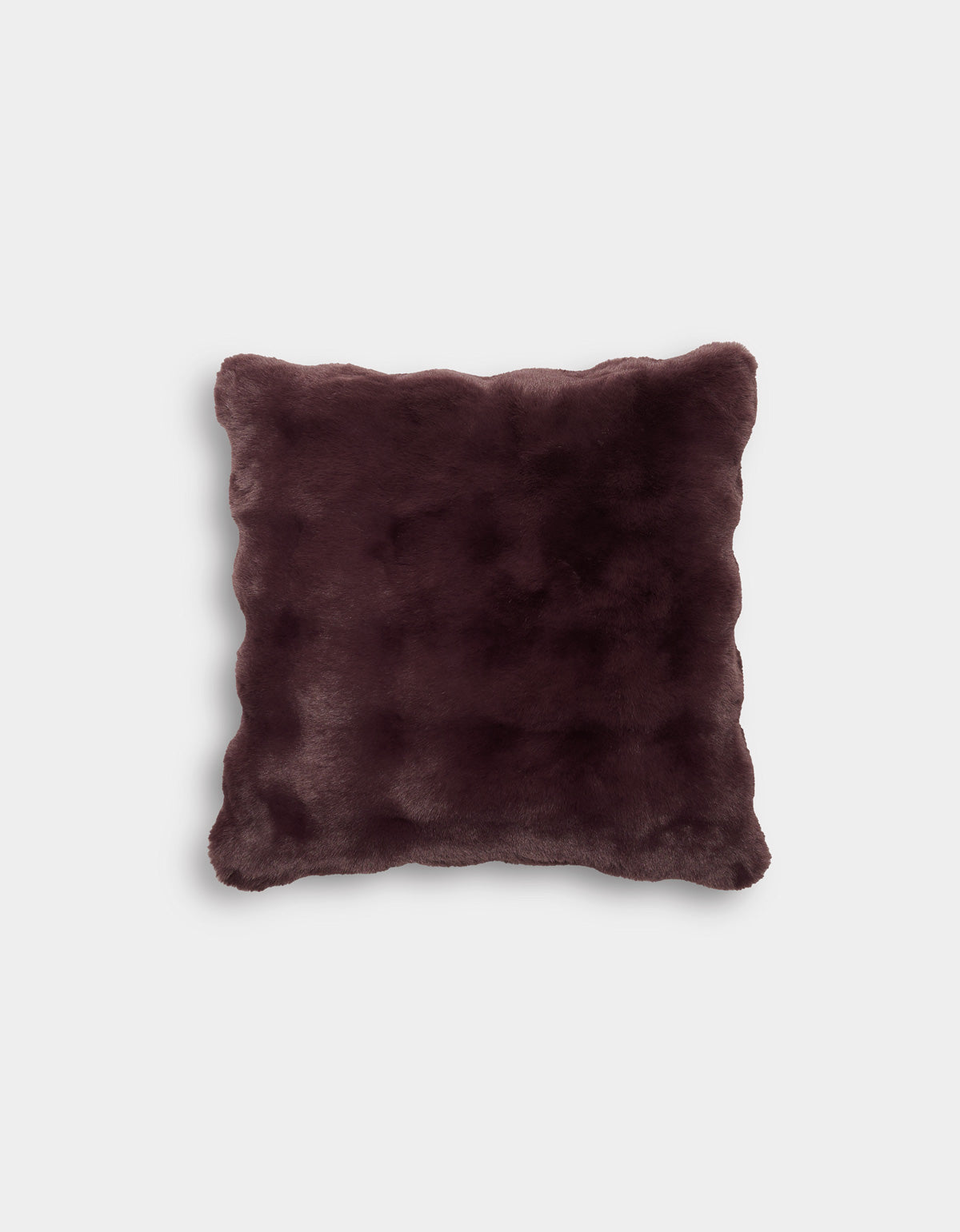 The Bubble Cuddle Pillow by Cozy Earth is displayed against a plain light gray background. This square pillow features a dark brown, faux fur cover with a soft, plush texture and gently rounded corners.