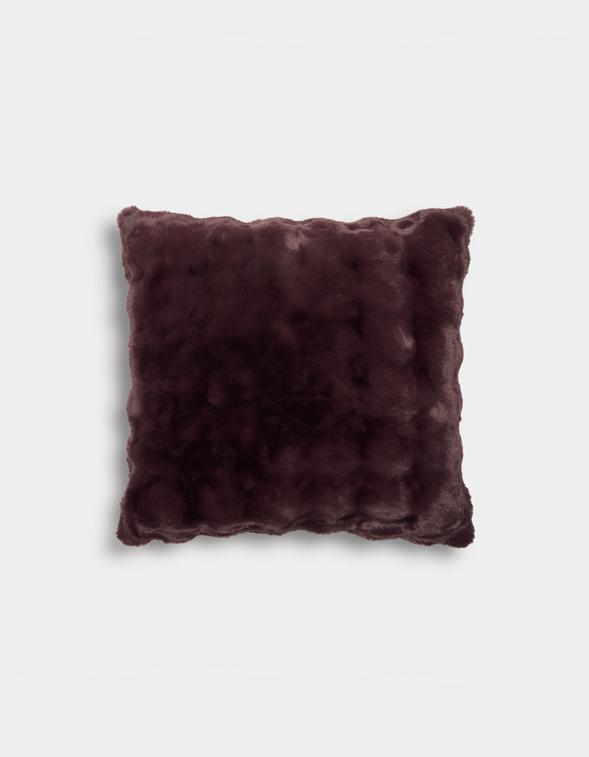 A square Bubble Cuddle Pillow by Cozy Earth, featuring a plush, velvety soft dark brown fabric with wavy edges, displayed against a plain white background.