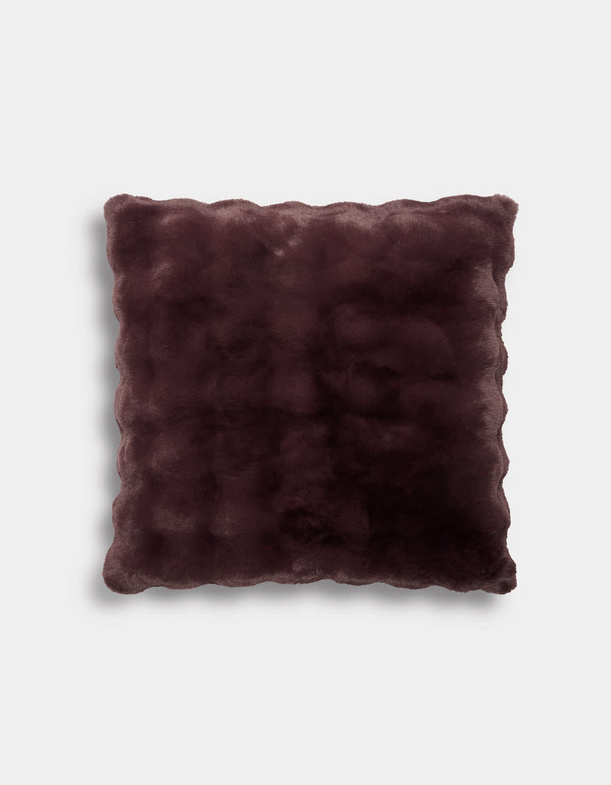 The Bubble Cuddle Pillow by Cozy Earth is a square, plush pillow featuring a rich dark burgundy color and elegant scalloped edges. Its soft, velvety surface rests against a plain light gray background.