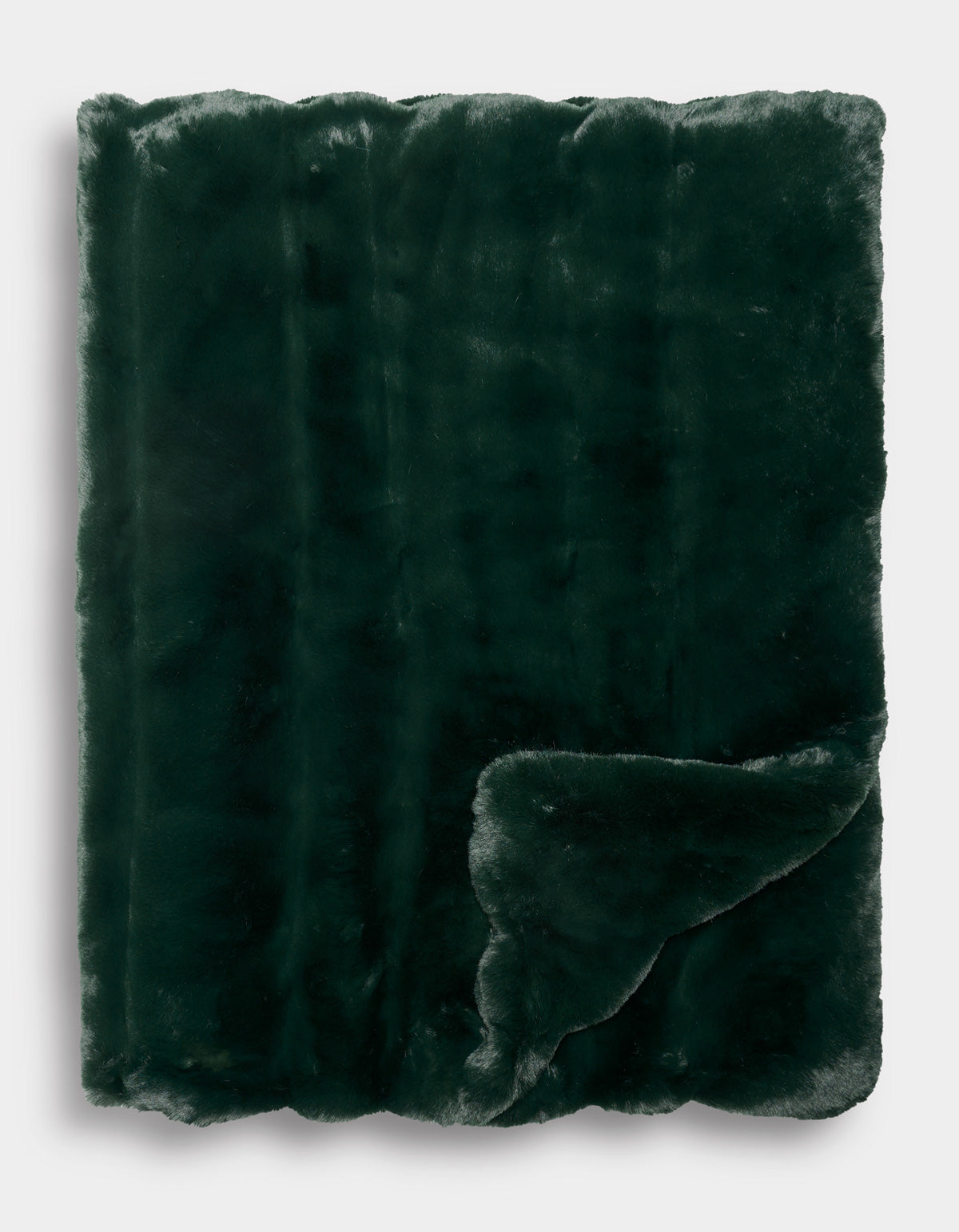 The Cozy Earth Channel Cuddle Blanket is neatly folded, with one corner turned up to reveal its plush texture on both sides. The dark green faux fur looks exceptionally soft and cozy.