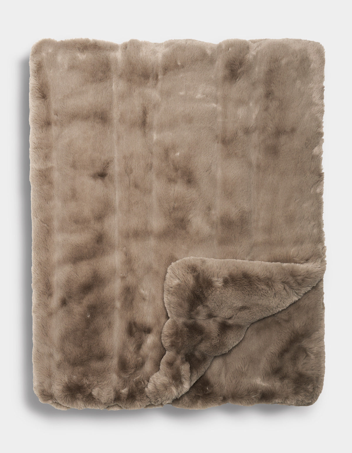 The Cozy Earth Channel Cuddle Blanket in a soft, light brown faux fur is neatly folded with one corner turned up, revealing its plush texture on both sides.