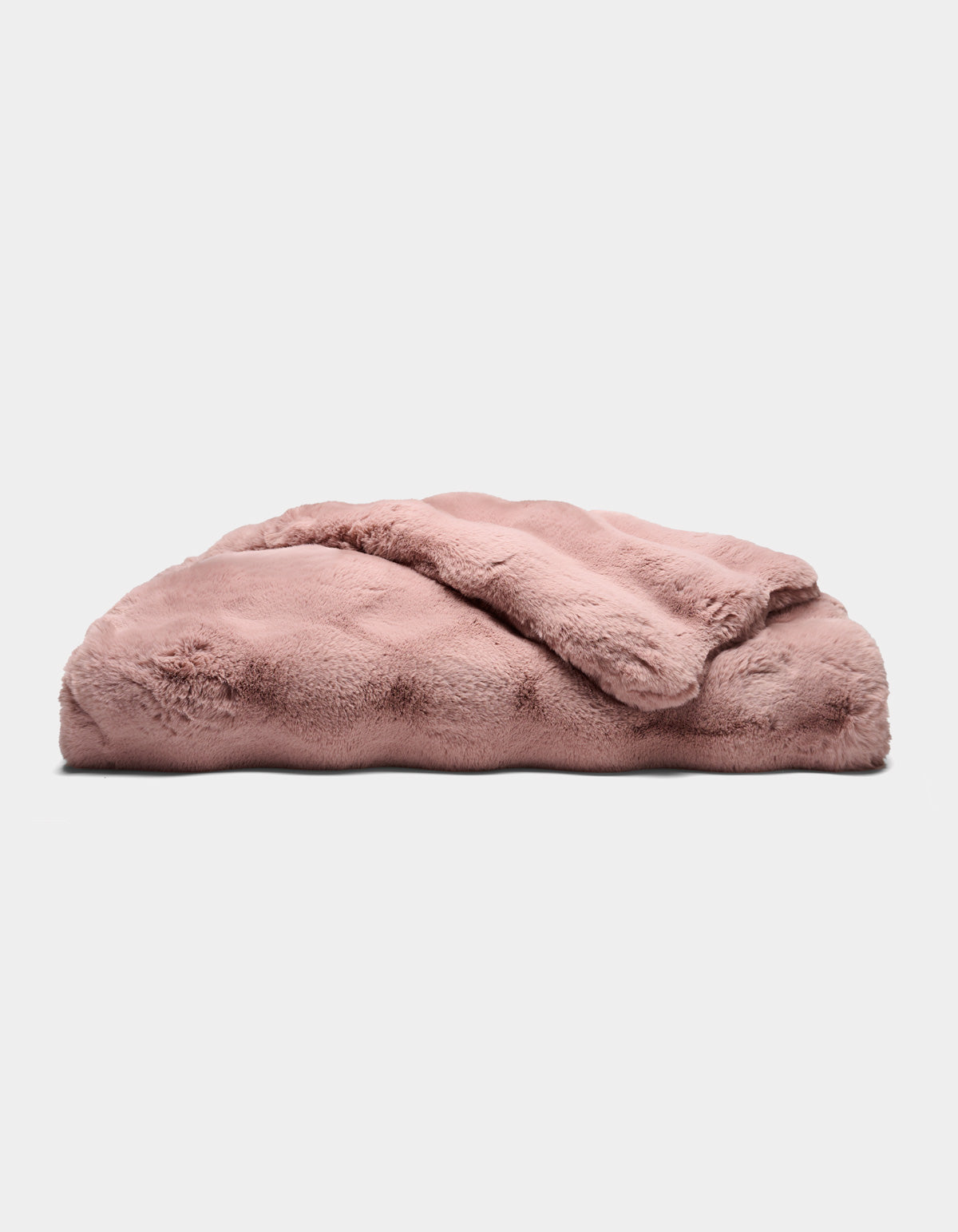 The Cozy Earth Double Bubble Cuddle Blanket, in plush light pink, is neatly folded and displayed on a flat surface against a plain white background.