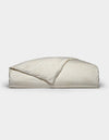 A folded Bamboo Duvet Cover by Cozy Earth in a light cream color with a subtle floral pattern is displayed on a plain white background.|Color:Sonoma Floral in Vintage White