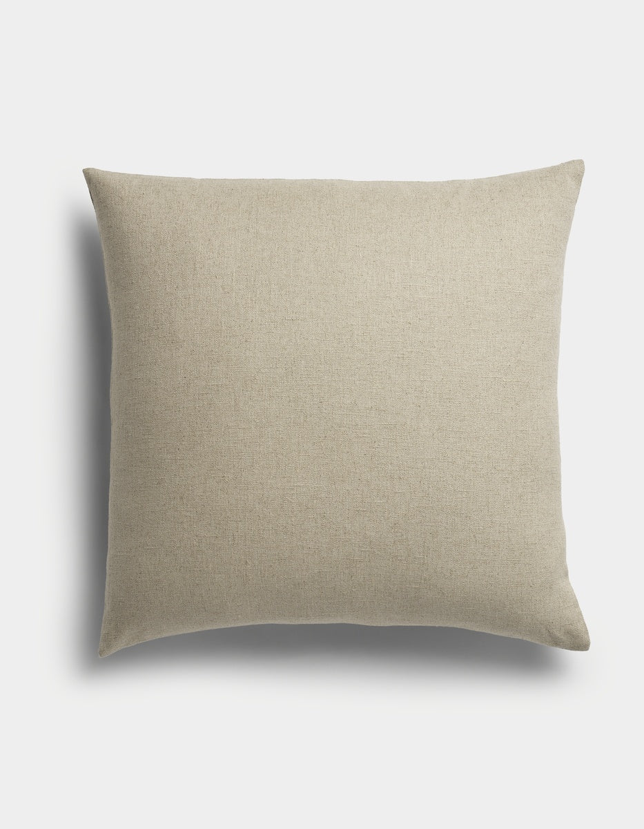The Sonoma Throw Pillow by Cozy Earth is a square, beige cushion featuring a plain fabric texture, displayed against a white background with a soft shadow to the left.|Color:Tallow|Size:26" x 26"