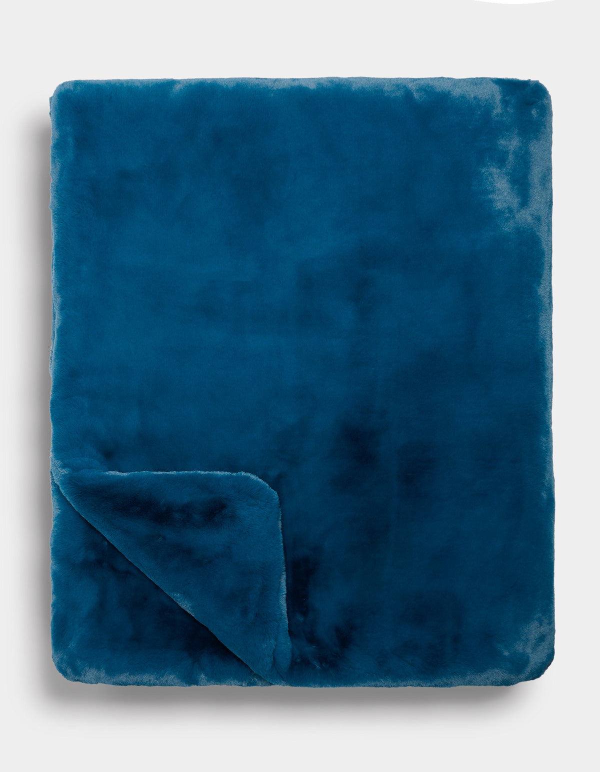A folded Superplush Cuddle Blanket by Cozy Earth in teal blue, with one corner turned up to reveal its luxuriously soft texture against a plain light background.