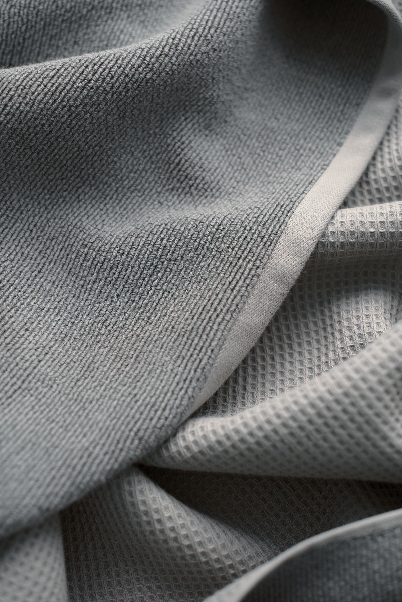 Waffle Bath Towel in the color Charcoal. Photo of Charcoal Waffle Bath Towel taken close up showing only the Charcoal. 