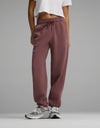 Person wearing mauve Women’s CityScape Sweatpant featuring a high-waisted drawstring design and elastic cuffs.|Color:Copper Rose