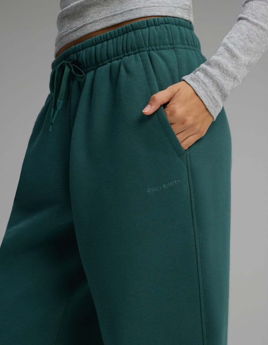 Dark green Cozy Earth Women’s CityScape Sweatpant featuring an elastic waistband, drawstring, side pockets, and a small brand logo on the hip.