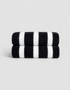 The Cozy Earth Classic Stripe Resort Towel Bundle features two neatly stacked towels with thick black and white stripes, set against a plain light gray background.|Color:Jet Black