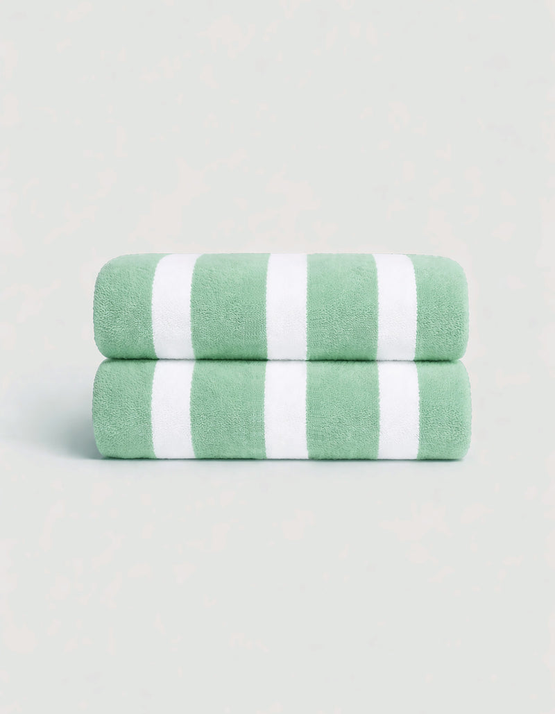 The Cozy Earth Classic Stripe Resort Towel Bundle features two neatly folded towels with wide green and white stripes, stacked together against a light background.