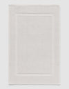 The Cozy Earth Classic Bath Mat features a rectangular shape, light color, subtle textured pattern, and elegant double border design on the edges.|Color:Light Grey