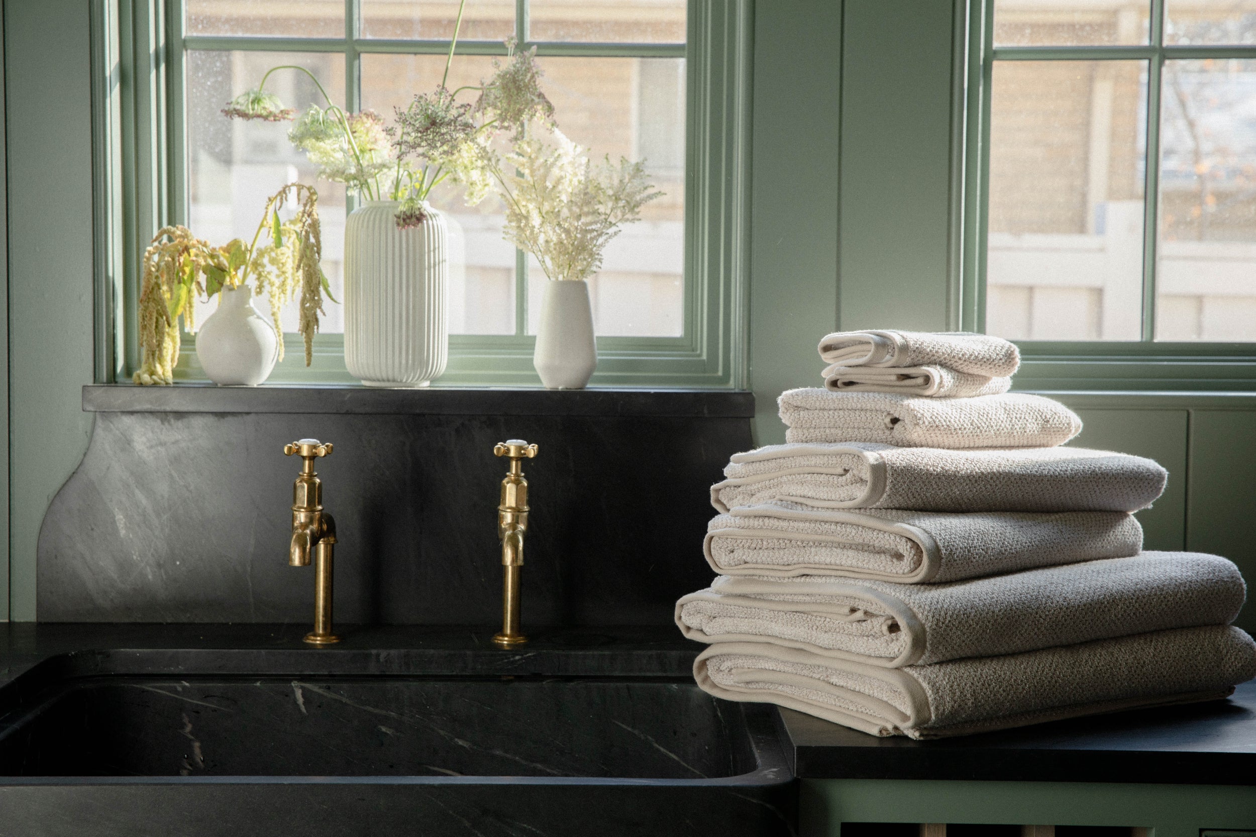 Nantucket Bath bundle on counter next to black sink with gold hardware
