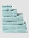 The Complete Luxe Bath Bundle by Cozy Earth features neatly stacked light blue towels in various sizes, arranged from largest to smallest against a plain light background.|Color:Tide