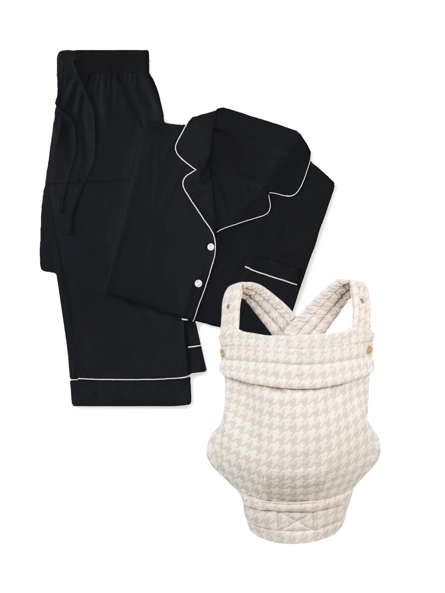 The Cozy Earth "test" black button-up pajama set with white trim is folded next to a cream and beige houndstooth-patterned baby carrier on a white background.