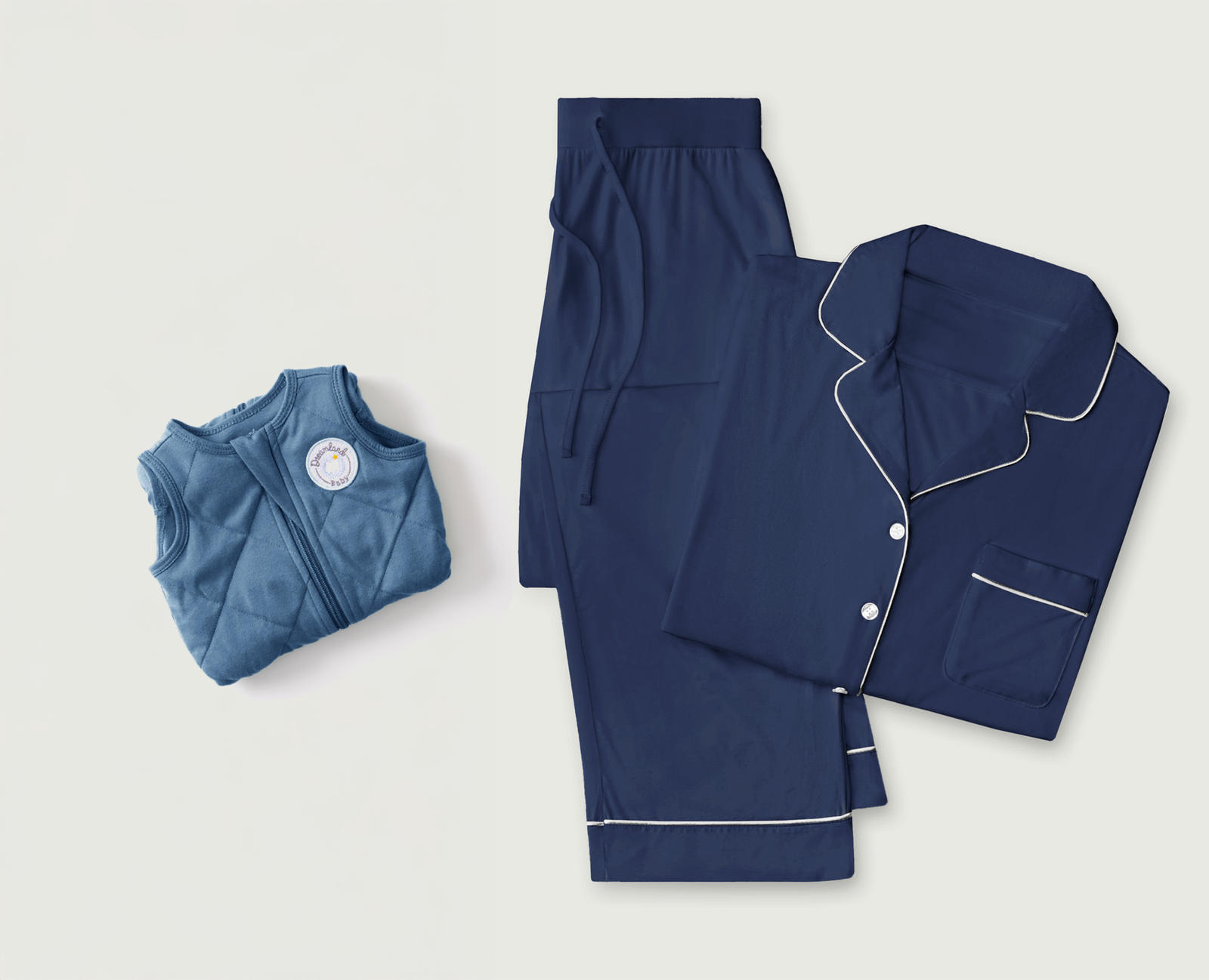 The Cozy Earth Women's Pajama Set in navy with white piping, including a long-sleeve top and pants, is displayed beside the Dreamland Weighted Sleep Sack in folded blue, both by Cozy Earth, on a white background.