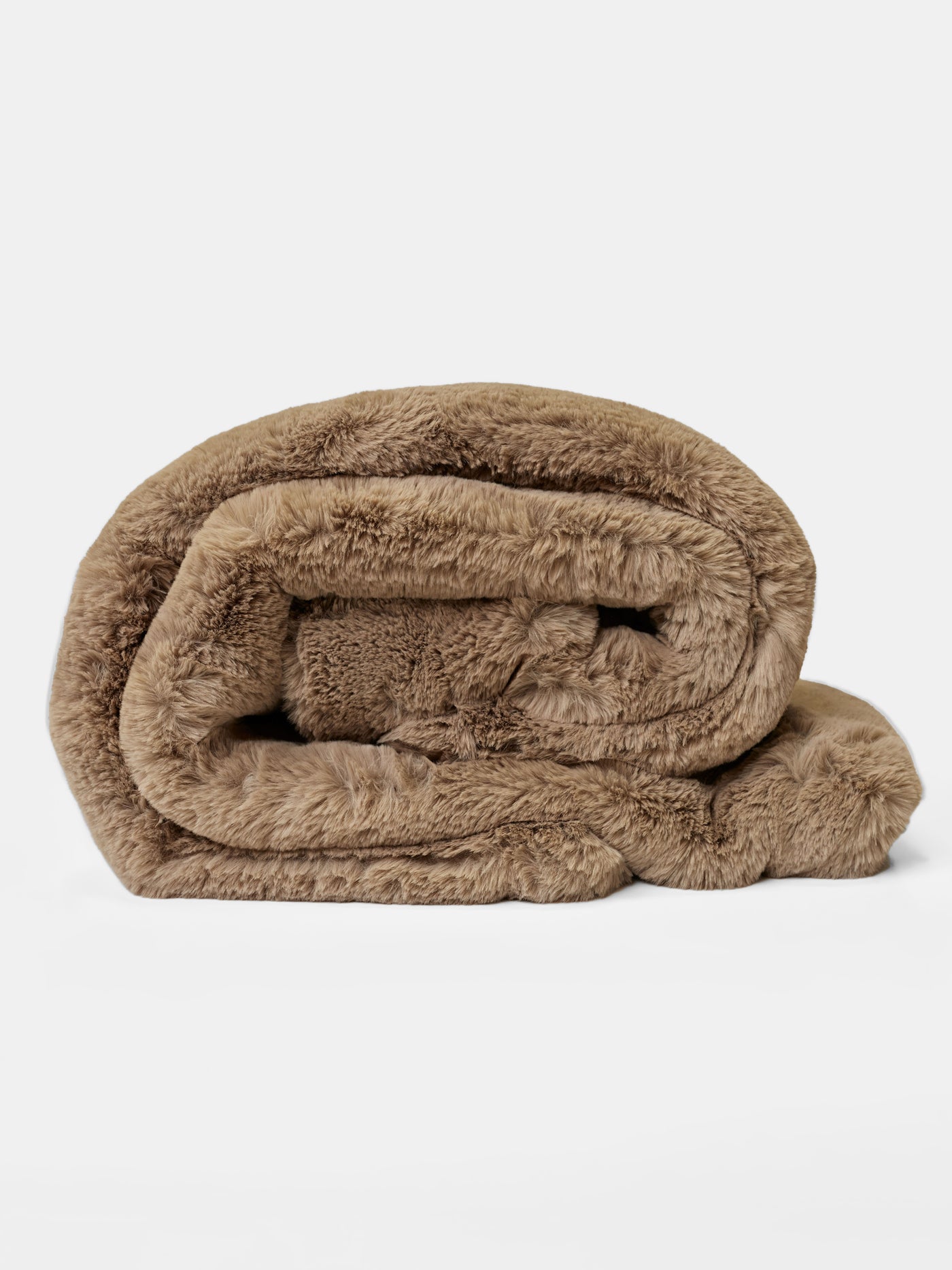 The Cuddle Blanket by Cozy Earth is neatly rolled against a plain white background, showcasing its plush brown faux fur. Its soft and cozy texture suggests warmth and comfort. |Color:Walnut