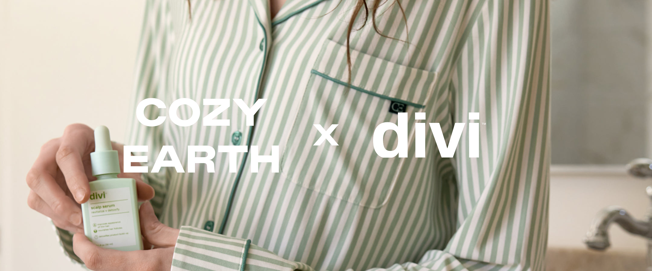 Person holding a bottle with 'Cozy Earth' and 'divi' branding.