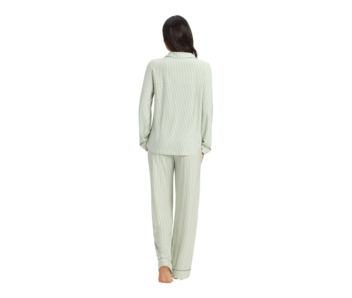 Woman wearing a light green pajama set on a white background
