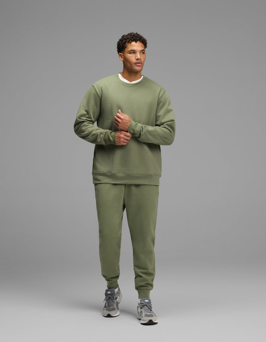 A man wearing an olive green Men’s Dylan Crewneck & Jogger Set.|Color:Marsh